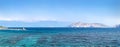 Summer panoramic landscape. A pier and a lighthouse in the harbor. Sailboats on the background of the island of Prvic and the Royalty Free Stock Photo